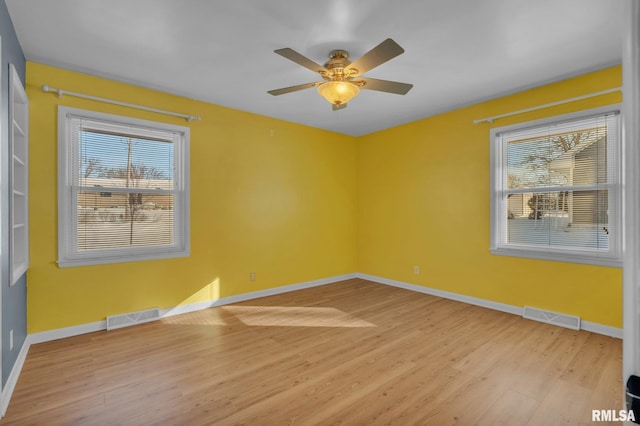 206 E 13th St, Tipton, IA 52772 - unfurnished room with light wood-style flooring and a ceiling fan