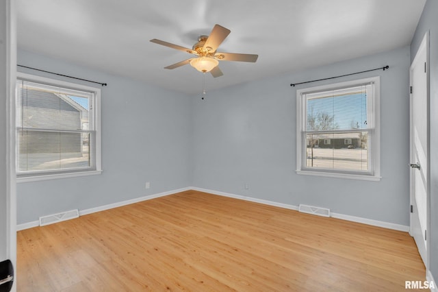 206 E 13th St, Tipton, IA 52772 - unfurnished room with healthy amount of natural light, light wood-style floors, and a ceiling fan