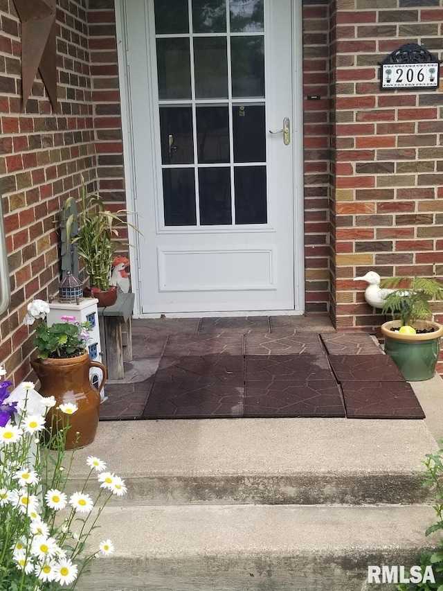 206 E 13th St, Tipton, IA 52772 - property entrance featuring brick siding