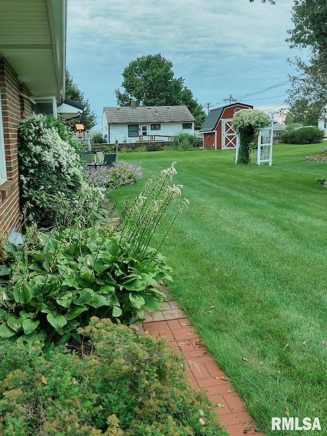 206 E 13th St, Tipton, IA 52772 - view of grassy yard with a barn and an outdoor structure