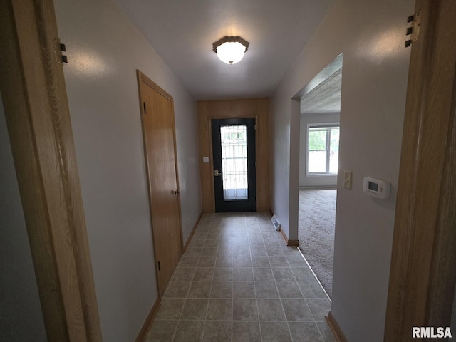 206 E 13th St, Tipton, IA 52772 - doorway to outside featuring light tile patterned flooring and baseboards