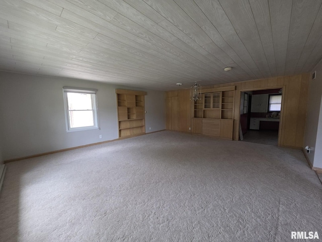 206 E 13th St, Tipton, IA 52772 - empty room with built in shelves, wooden ceiling, and carpet flooring