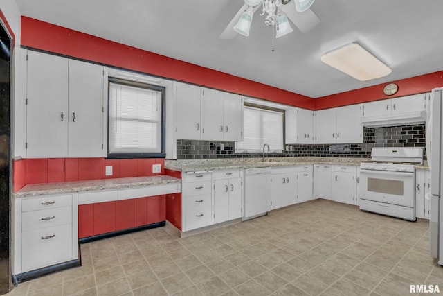 206 E 13th St, Tipton, IA 52772 - kitchen featuring white appliances, light countertops, ceiling fan, under cabinet range hood, and backsplash