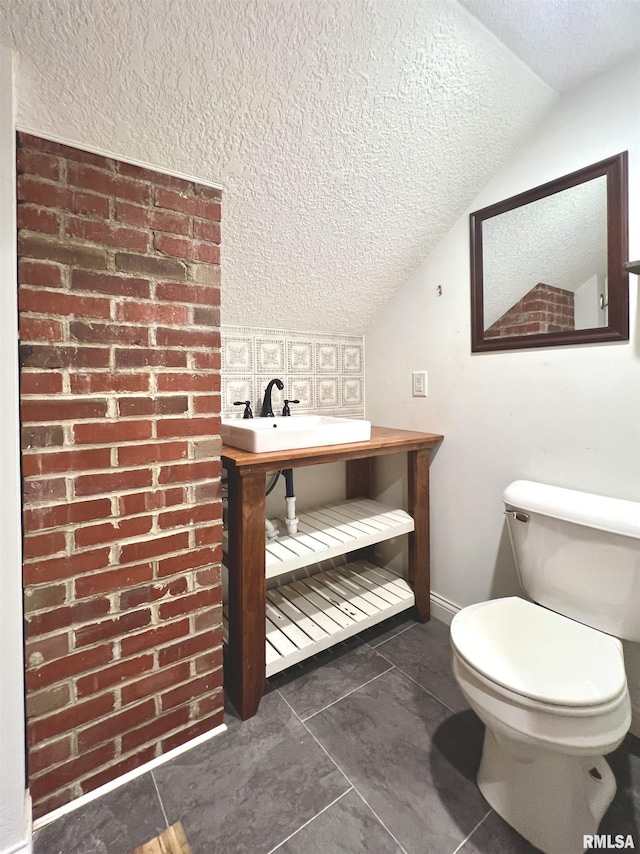 1130 53rd St, Moline, IL 61265 - bathroom with a textured ceiling, vaulted ceiling, and tile patterned floors