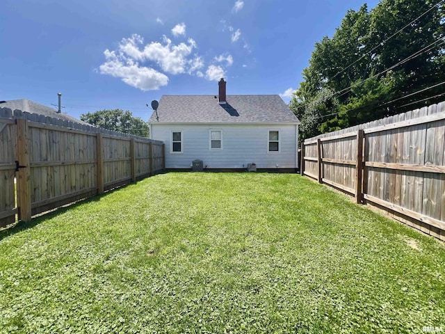 1130 53rd St, Moline, IL 61265 - back of property featuring a chimney and a fenced backyard