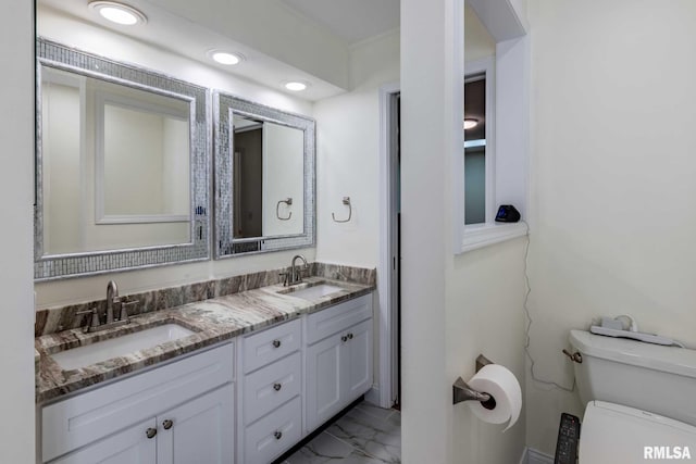901 E Gregory Ave, Marion, IL 62959 - bathroom with marble look tiles, double vanity, and recessed lighting