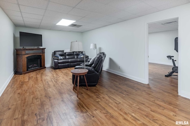 901 E Gregory Ave, Marion, IL 62959 - living area featuring wood finished floors, a fireplace, and a drop ceiling