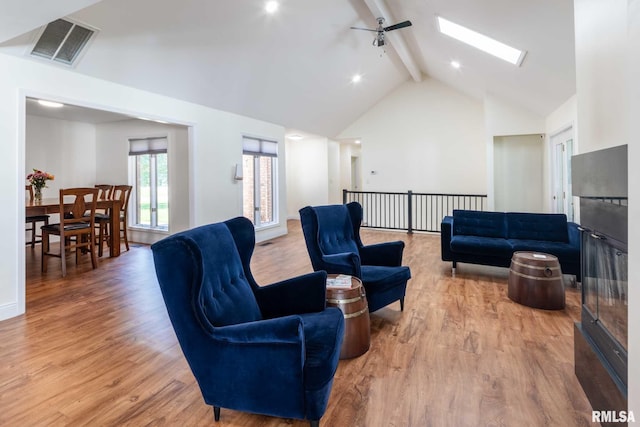 901 E Gregory Ave, Marion, IL 62959 - living room featuring beam ceiling, a skylight, light wood-type flooring, and high vaulted ceiling