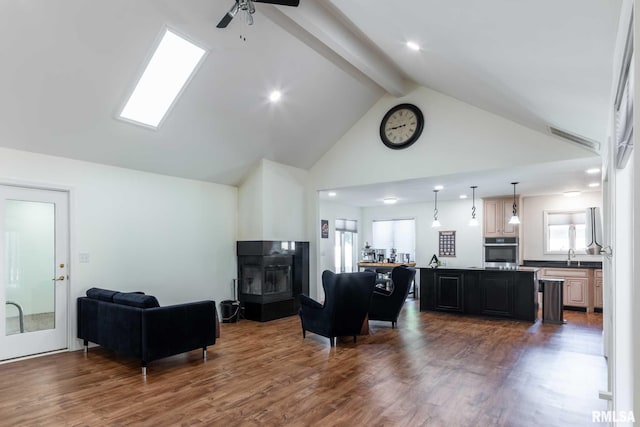 901 E Gregory Ave, Marion, IL 62959 - living area with high vaulted ceiling, beam ceiling, wood finished floors, ceiling fan, and a multi sided fireplace