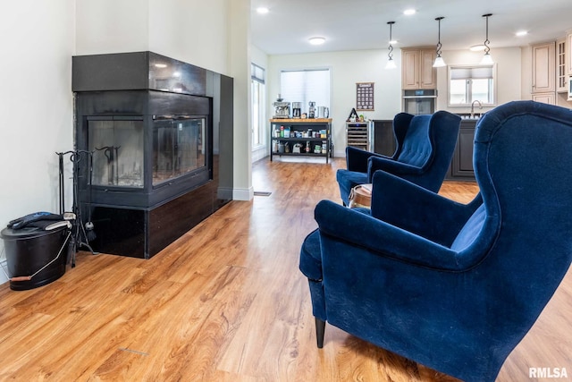 901 E Gregory Ave, Marion, IL 62959 - living area with light wood-type flooring, a glass covered fireplace, and beverage cooler