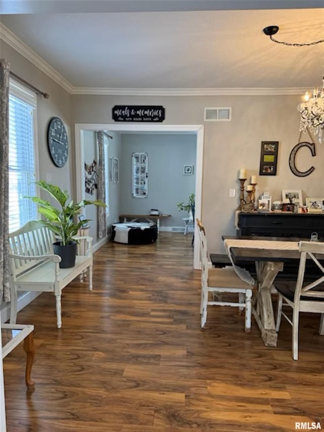 3119 15th St Unit C, Moline, IL 61265 - dining area featuring a chandelier, wood finished floors, and crown molding