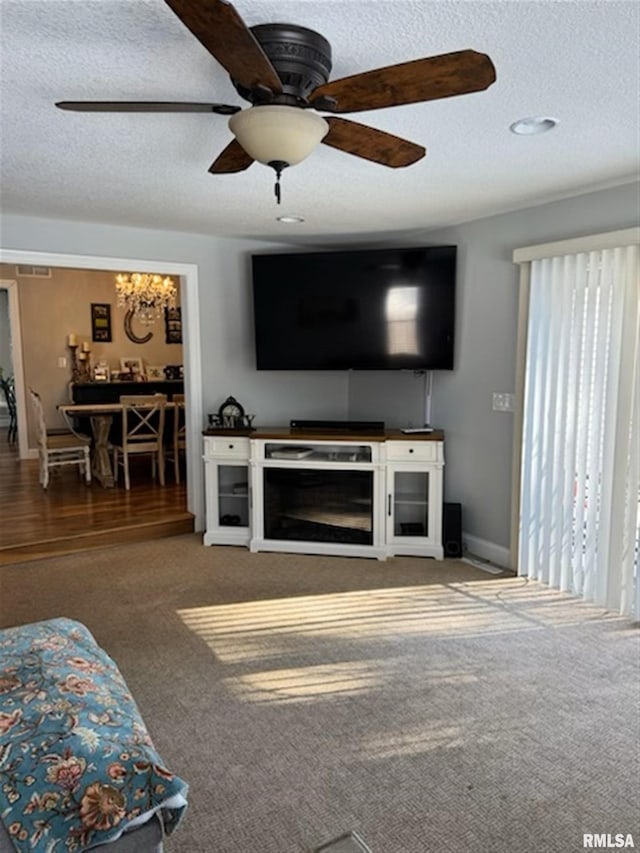 3119 15th St Unit C, Moline, IL 61265 - living area featuring a textured ceiling, carpet flooring, and a ceiling fan