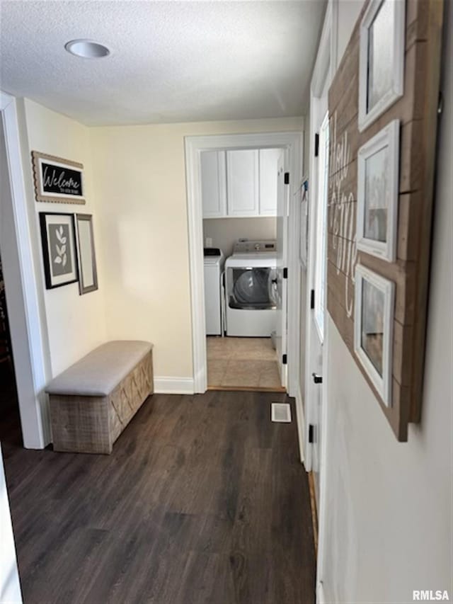 3119 15th St Unit C, Moline, IL 61265 - corridor featuring washer and clothes dryer, dark wood-style flooring, and a textured ceiling