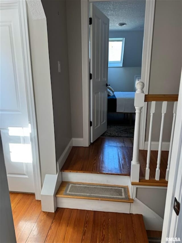 3119 15th St Unit C, Moline, IL 61265 - stairway featuring hardwood / wood-style floors and a textured ceiling