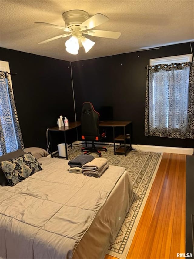 3119 15th St Unit C, Moline, IL 61265 - bedroom featuring a textured ceiling, wood finished floors, and a ceiling fan