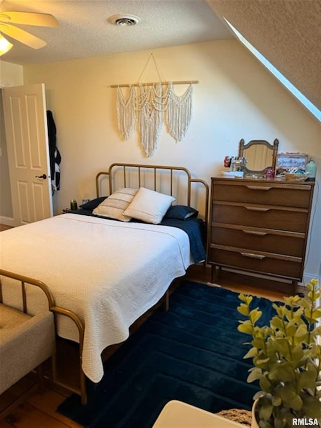 3119 15th St Unit C, Moline, IL 61265 - bedroom featuring a textured ceiling, vaulted ceiling, and wood finished floors