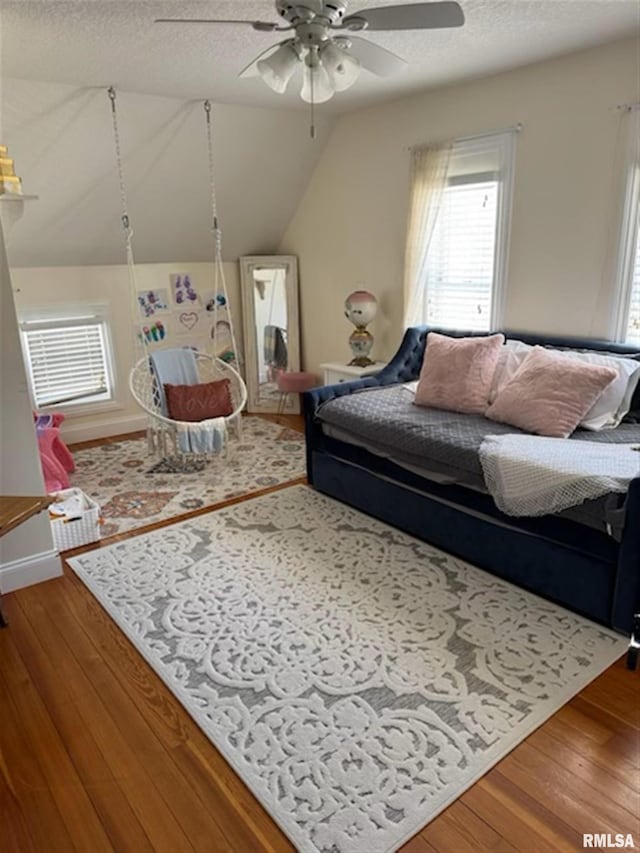 3119 15th St Unit C, Moline, IL 61265 - living area with ceiling fan, hardwood / wood-style floors, a textured ceiling, and vaulted ceiling