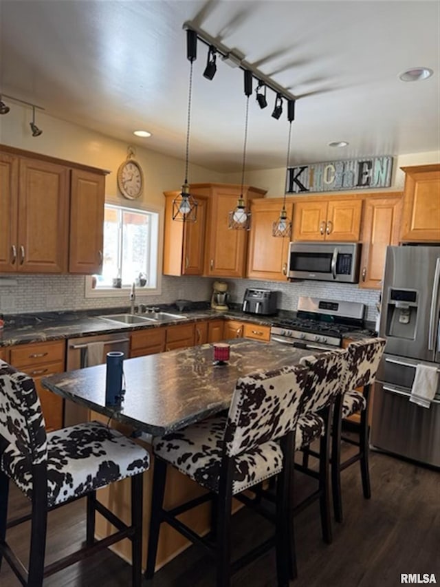 3119 15th St Unit C, Moline, IL 61265 - kitchen with appliances with stainless steel finishes, dark wood-style flooring, dark countertops, decorative backsplash, and brown cabinets