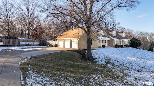 3 Brown Ct, Bettendorf, IA 52722 - view of snow covered exterior with driveway and a garage