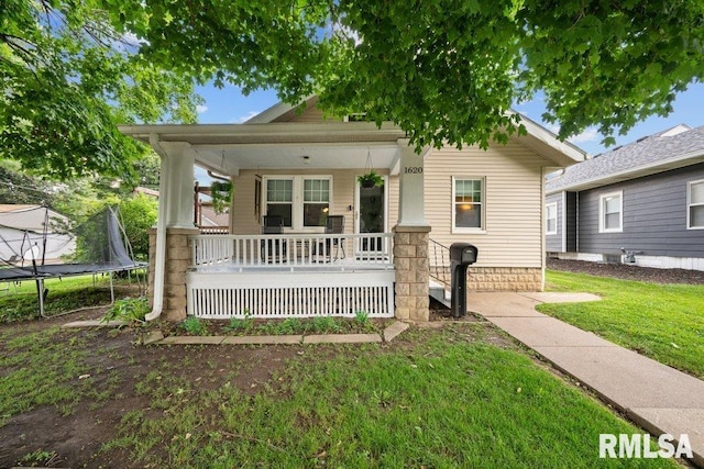 1620 24th St, Moline, IL 61265 - view of front of property with a porch, a trampoline, and a front yard