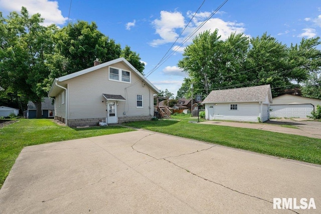 1620 24th St, Moline, IL 61265 - rear view of property with an outbuilding, a lawn, and a garage