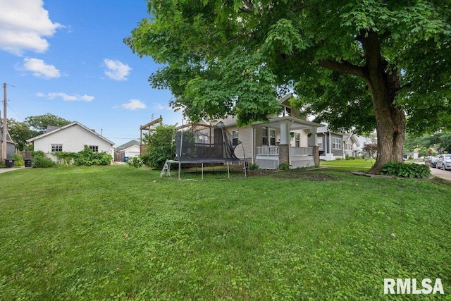 1620 24th St, Moline, IL 61265 - view of grassy yard with a trampoline and a porch
