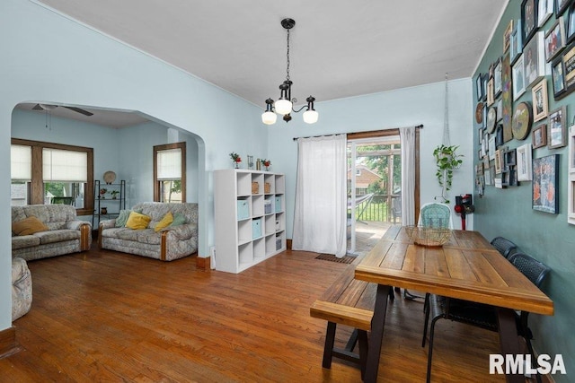1620 24th St, Moline, IL 61265 - dining space with arched walkways, wood finished floors, a chandelier, and a ceiling fan