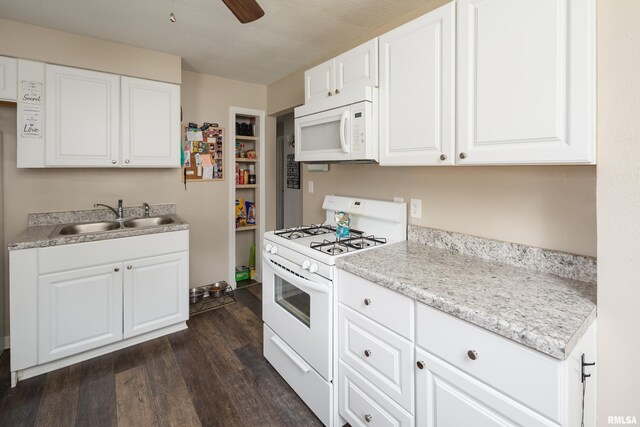 419 50th St, Moline, IL 61265 - kitchen featuring white appliances, dark wood finished floors, light countertops, and white cabinetry