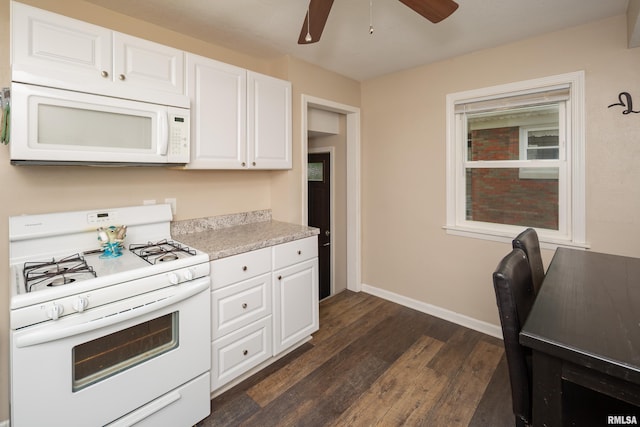 419 50th St, Moline, IL 61265 - kitchen featuring white appliances, dark wood-style floors, ceiling fan, and white cabinets