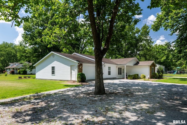 4182 Baptist Camp Rd, Carterville, IL 62918 - view of front of house featuring driveway, an attached garage, a front yard, and view of wooded area