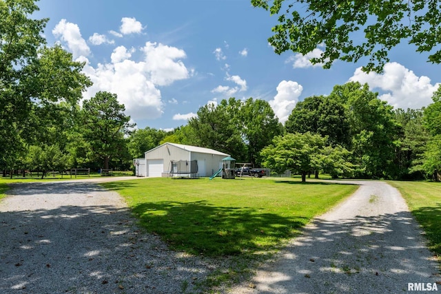 4182 Baptist Camp Rd, Carterville, IL 62918 - view of front of home with driveway, a front yard, a garage, and an outbuilding