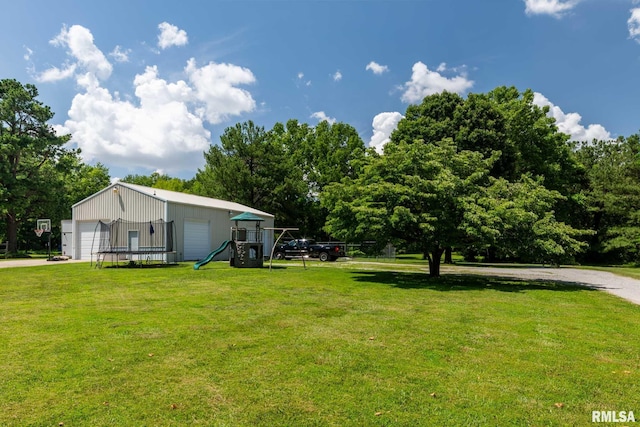 4182 Baptist Camp Rd, Carterville, IL 62918 - view of green lawn with a detached garage and an outdoor structure