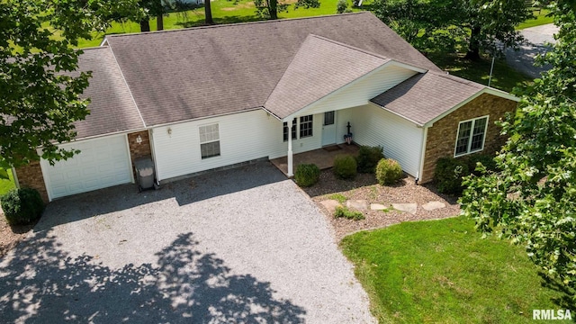 4182 Baptist Camp Rd, Carterville, IL 62918 - view of front of property with gravel driveway, a shingled roof, an attached garage, stone siding, and a front lawn