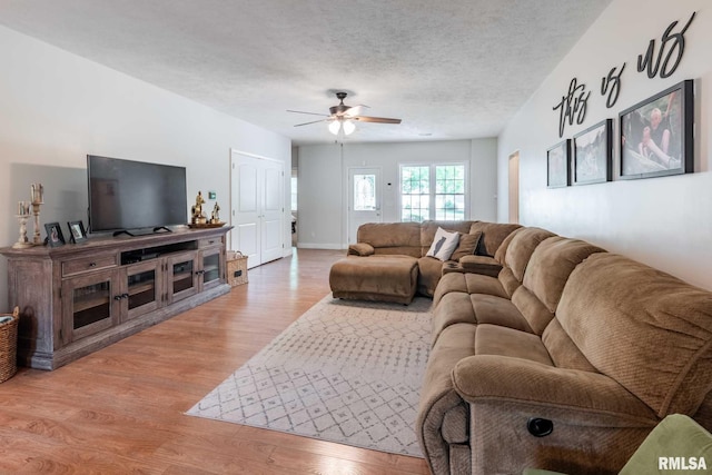 4182 Baptist Camp Rd, Carterville, IL 62918 - living room featuring light wood-style flooring, a ceiling fan, and a textured ceiling