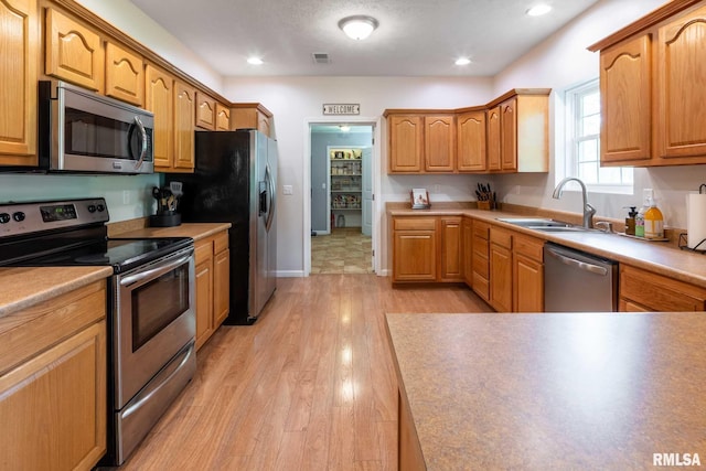 4182 Baptist Camp Rd, Carterville, IL 62918 - kitchen featuring appliances with stainless steel finishes, light wood-type flooring, and recessed lighting