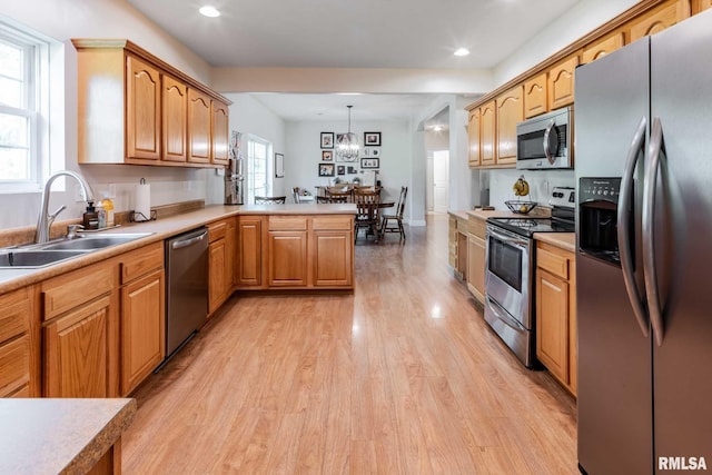4182 Baptist Camp Rd, Carterville, IL 62918 - kitchen with stainless steel appliances, light wood finished floors, a peninsula, light countertops, and recessed lighting