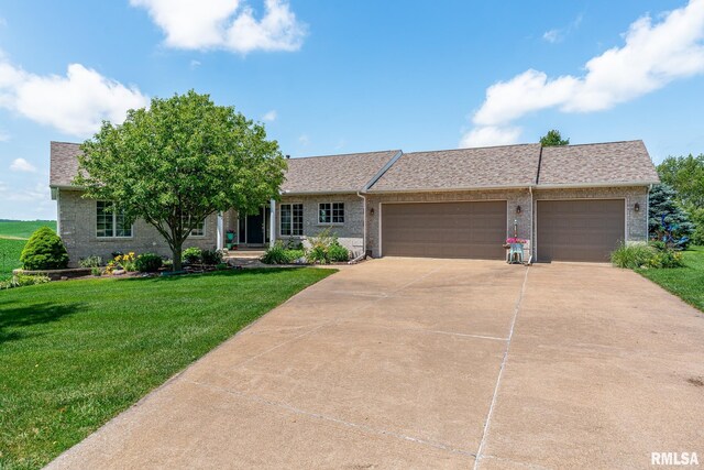 27062 238th St, Le Claire, IA 52753 - ranch-style house featuring an attached garage, brick siding, a front yard, driveway, and a shingled roof