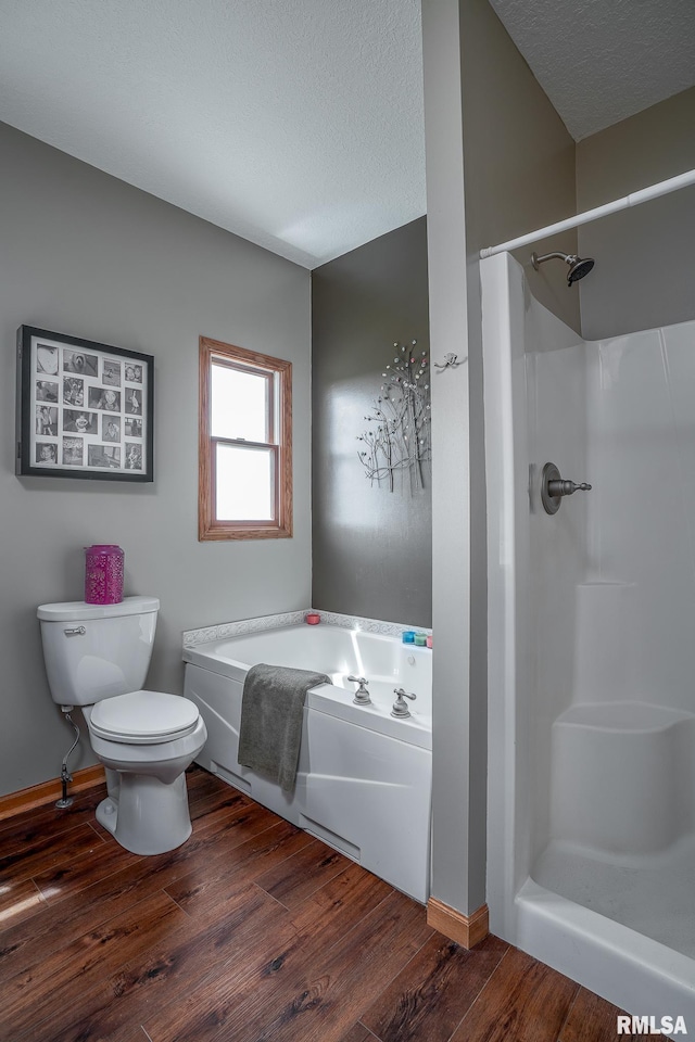 27062 238th St, Le Claire, IA 52753 - bathroom with wood finished floors, a bath, a textured ceiling, and a shower