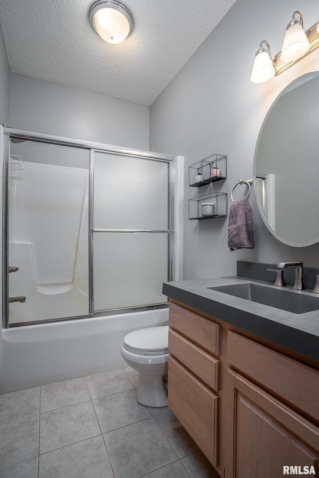 27062 238th St, Le Claire, IA 52753 - full bathroom with vanity, a textured ceiling, bath / shower combo with glass door, and tile patterned flooring