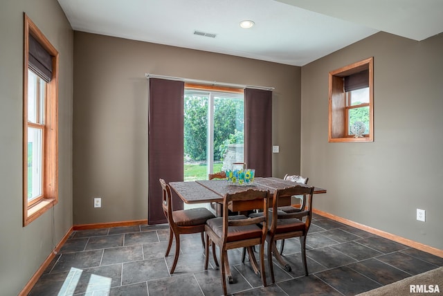 27062 238th St, Le Claire, IA 52753 - dining space with healthy amount of natural light, dark stone finish flooring, and recessed lighting