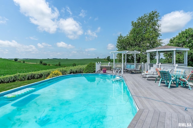 27062 238th St, Le Claire, IA 52753 - view of swimming pool featuring a gazebo, a wooden deck, and a view of countryside