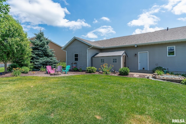 27062 238th St, Le Claire, IA 52753 - back of house with a fire pit and a yard