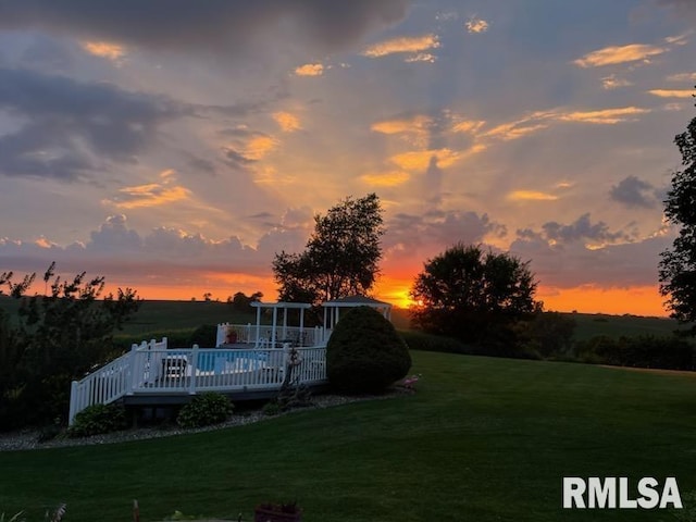27062 238th St, Le Claire, IA 52753 - yard at dusk with a yard and a deck