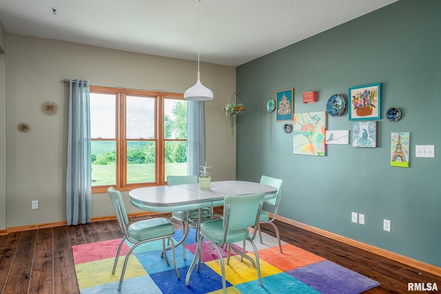 27062 238th St, Le Claire, IA 52753 - dining area featuring dark wood-type flooring and baseboards