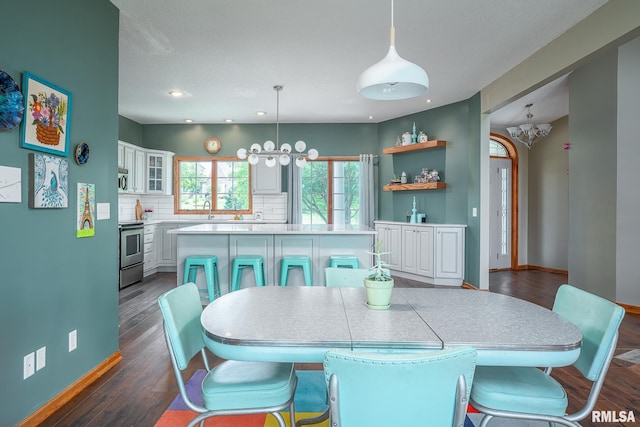 27062 238th St, Le Claire, IA 52753 - dining room featuring a chandelier, dark wood finished floors, and recessed lighting
