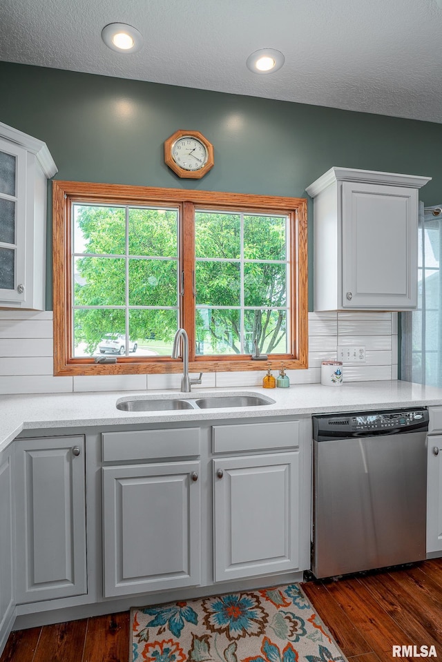 27062 238th St, Le Claire, IA 52753 - kitchen with dishwasher, white cabinetry, dark wood-type flooring, a textured ceiling, and glass insert cabinets