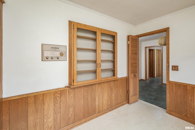 1427 35th Ave, Rock Island, IL 61201 - hallway featuring wooden walls, a wainscoted wall, and crown molding