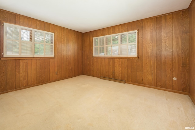 1427 35th Ave, Rock Island, IL 61201 - spare room with plenty of natural light, a baseboard radiator, wooden walls, and carpet flooring