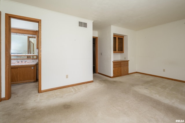 1427 35th Ave, Rock Island, IL 61201 - unfurnished room with light colored carpet and ornamental molding