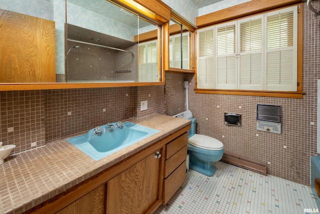 1427 35th Ave, Rock Island, IL 61201 - bathroom featuring a baseboard radiator, a tile shower, vanity, tile walls, and tile patterned flooring